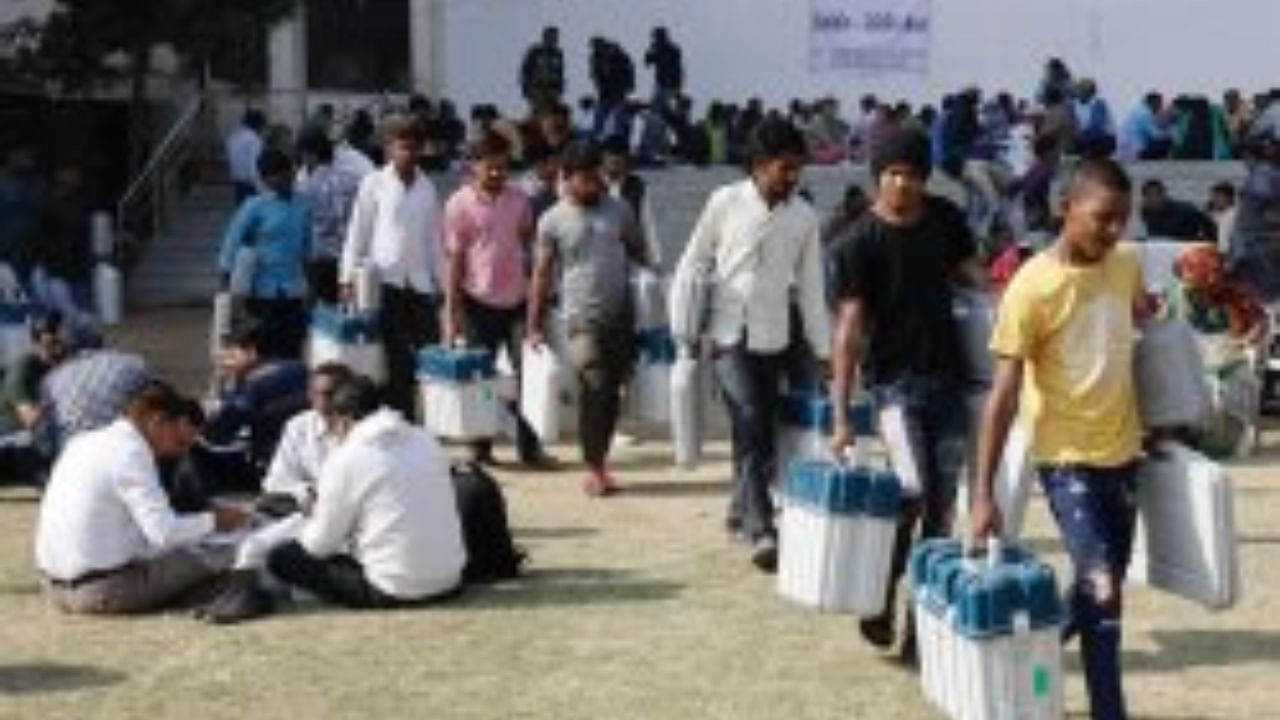 Polling officials leave for their respective polling stations ahead of the final phase of Gujarat Assembly elections in Ahmedabad. Credit: PTI File Photo