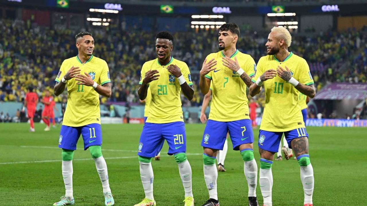 Brazil players celebrate scoring against South Korea. Credit: AFP Photo
