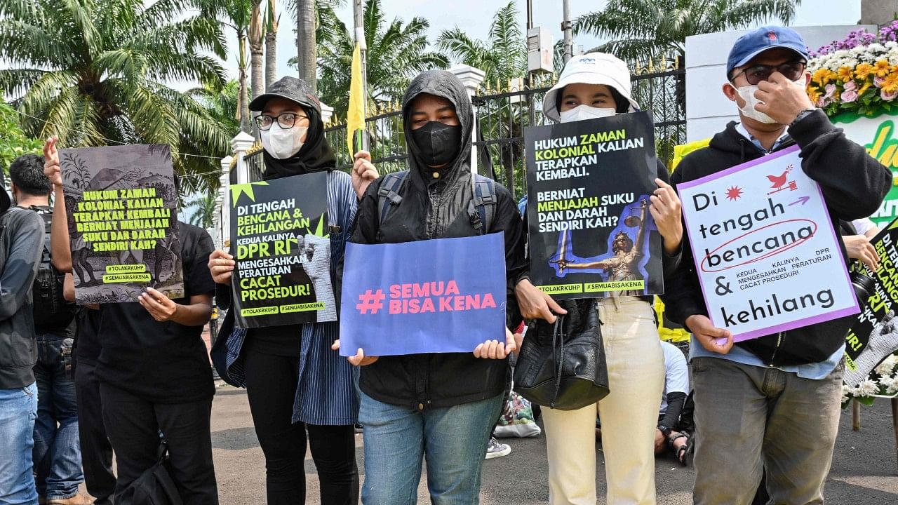 This picture taken on December 5, 2022 shows activists holding a protest against the new criminal code outside the parliament building in Jakarta. Credit: AFP Photo