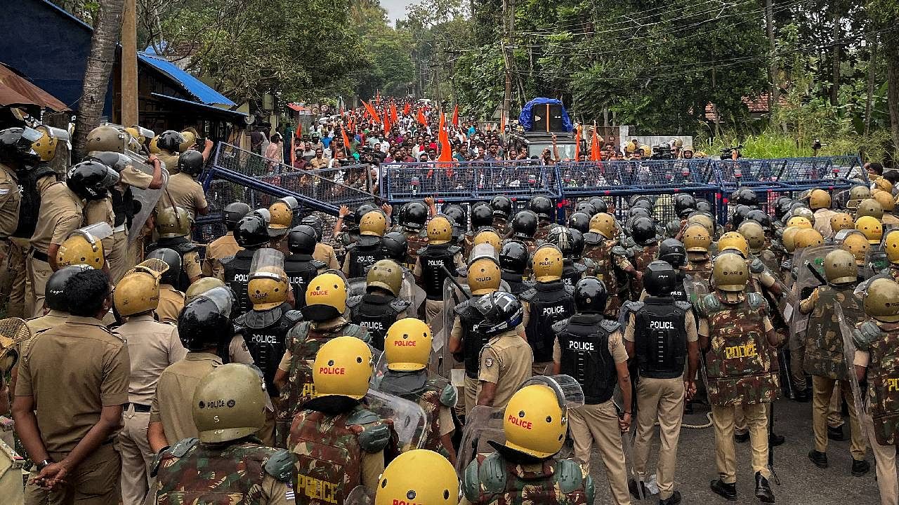 Police officers stand guard near the barricades during a protest rally by the supporters of the proposed Vizhinjam port project. Credit: Reuters File Photo