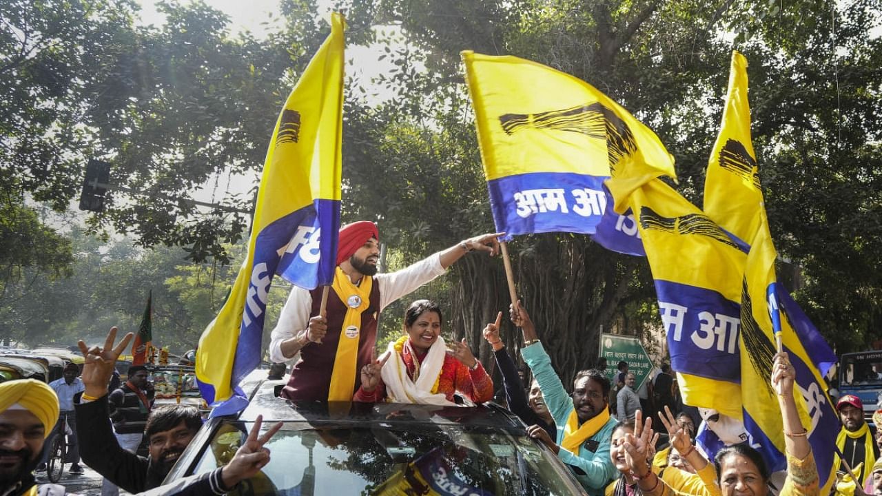 AAP candidate from the Inder Puri ward Jyoti Gautam celebrates her win with supporters outside a counting centre for the MCD elections at Patel Nagar, in New Delhi. Credit: PTI Photo