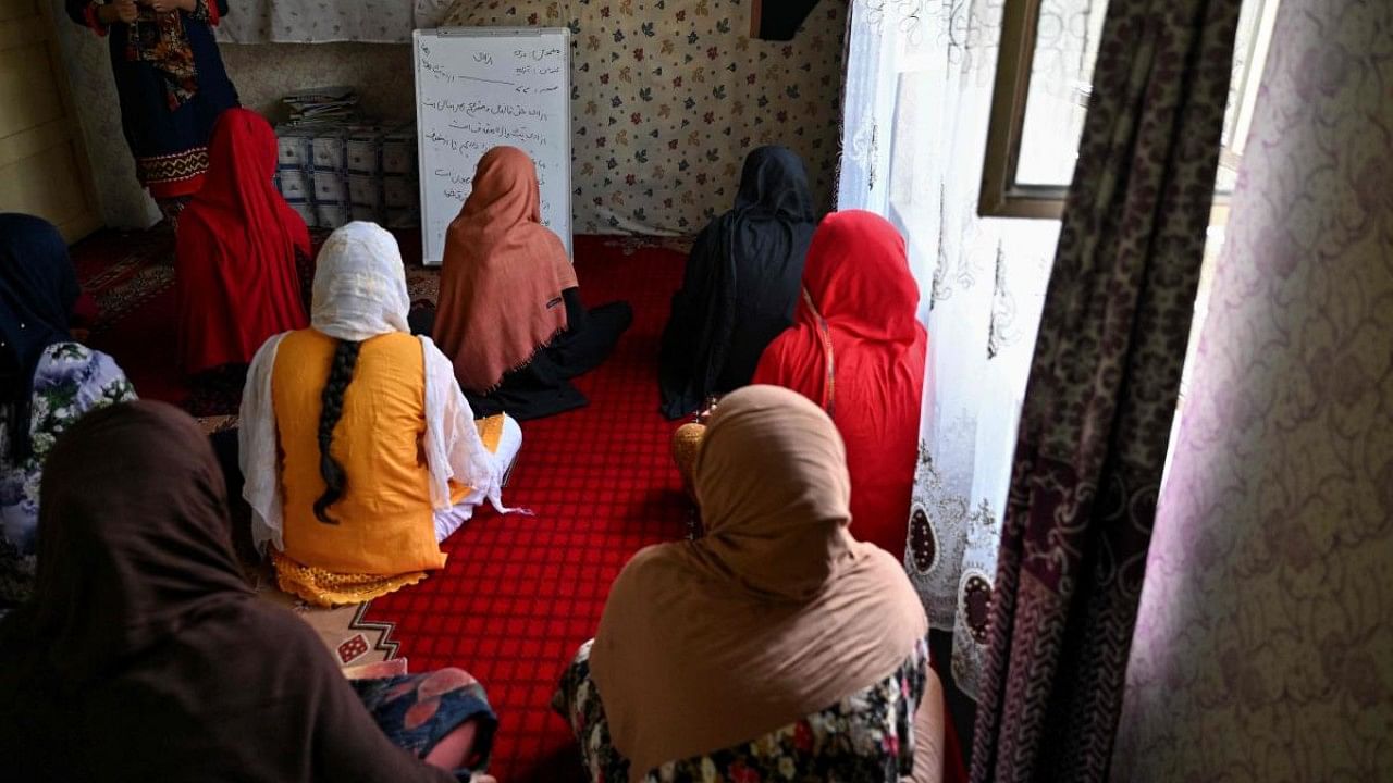 This photo taken on July 24, 2022 shows girls studying in a secret school at an undisclosed location in Afghanistan. Credit: AFP File Photo