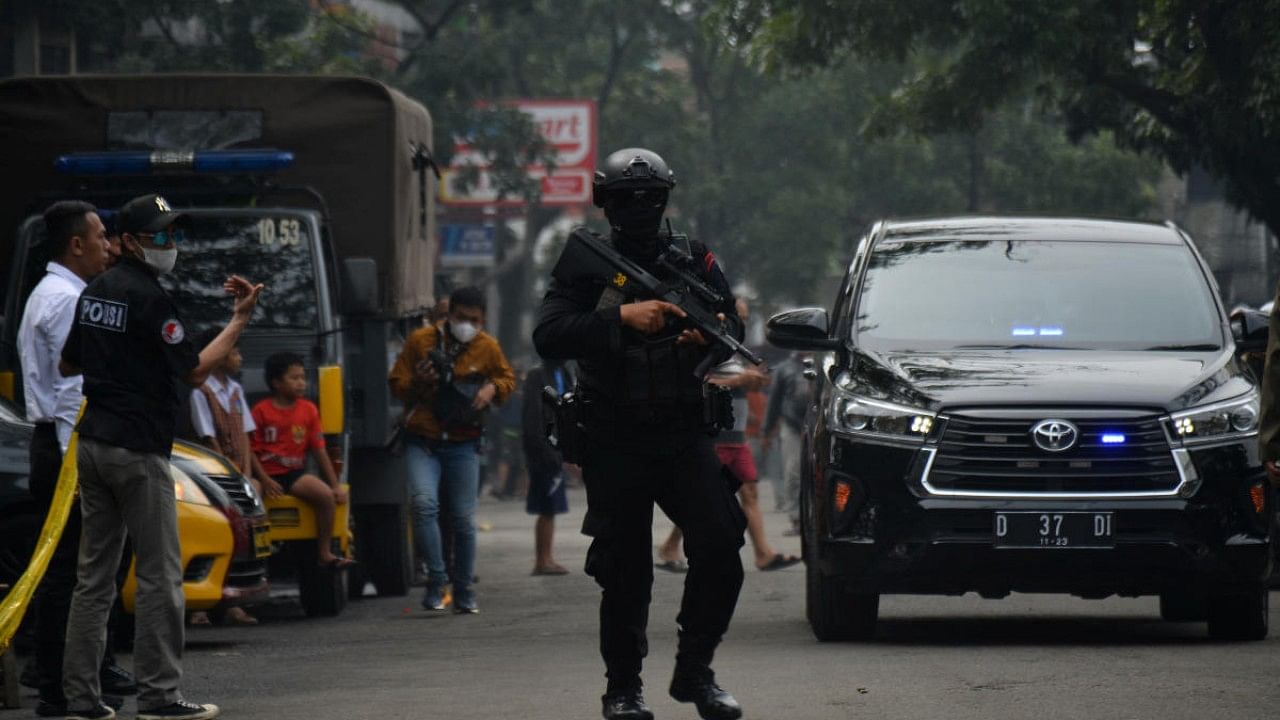 Policeman stands guard at the site of a blast at a police station in Bandung, West Java, Indonesia. Credit: Antara Foto/Raisan Al Farisi/ via Reuters Photo