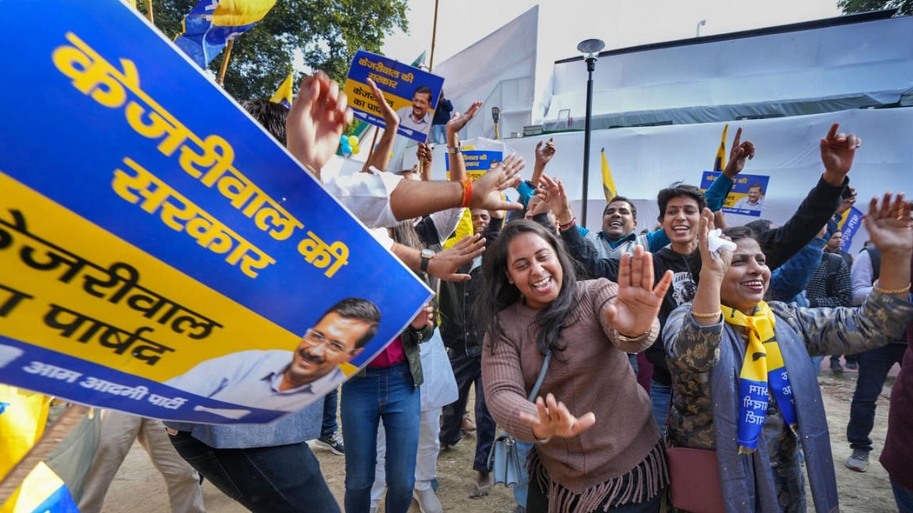 AAP supporters dance as they celebrate the party's victory in the MCD polls, in New Delhi. credit: PTI Photo