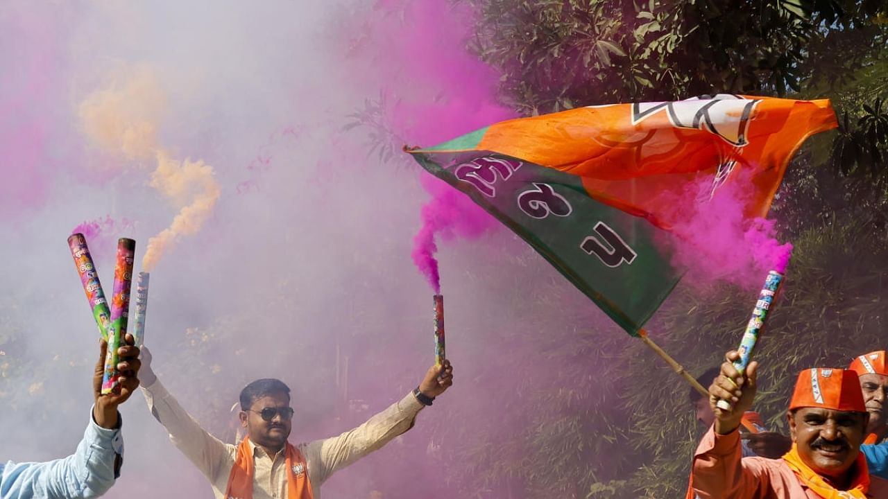 BJP workers burn firecrackers celebrating the party's decisive lead in Gujarat Assembly elections, in Gandhinagar, Thursday, Dec. 8, 2022. Credit: PTI Photo