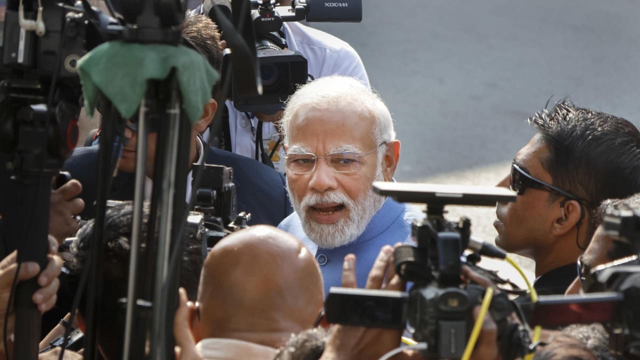 Prime Minister Narendra Modi speaks with media after casting his vote at a polling booth during the second and final phase of Gujarat Assembly elections, at Ranip area in Ahmedabad. Credit: PTI Photo