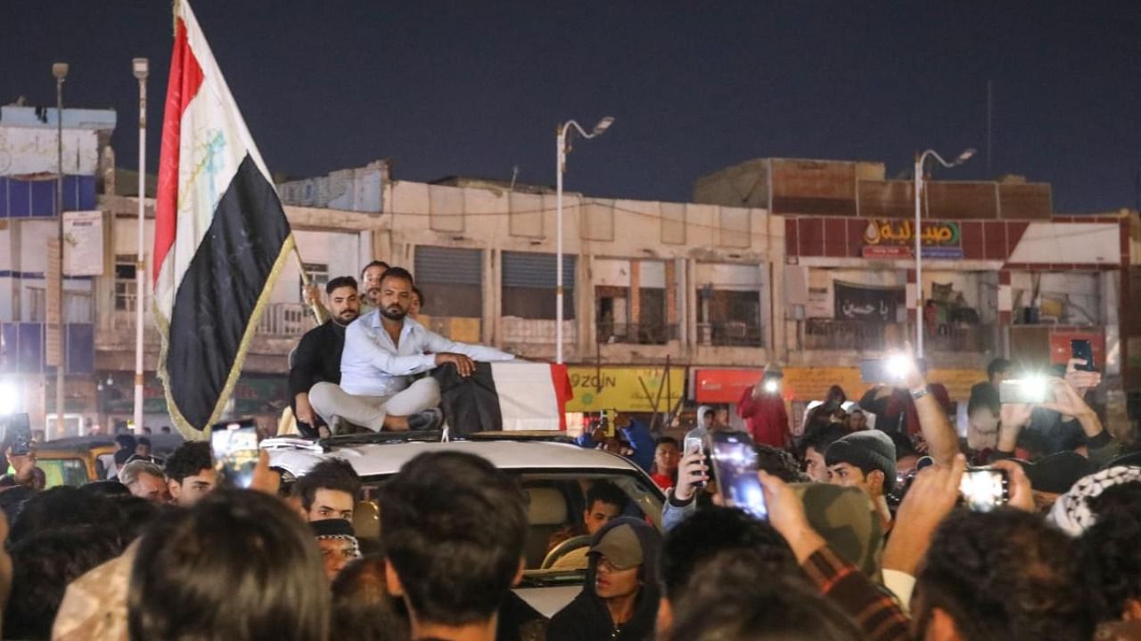 Mourners accompany the casket of one of the 2 protesters killed earlier in clashes with security forces, in the southern Iraqi city of Nasiriyah. Credit: AFP Photo