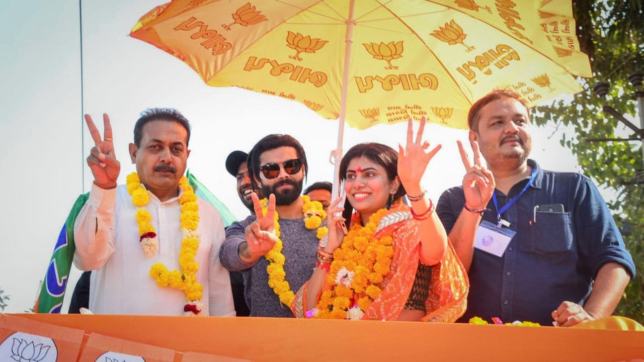 BJP candidate Rivaba Jadeja with husband and cricketer Ravindra Jadeja during a celebration rally after her victory in the Gujarat Assembly. Credit: PTI Photo