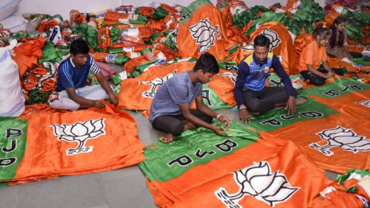 Workers prepare BJP party flags ahead of the Gujarat Assembly elections. Credit: PTI Photo