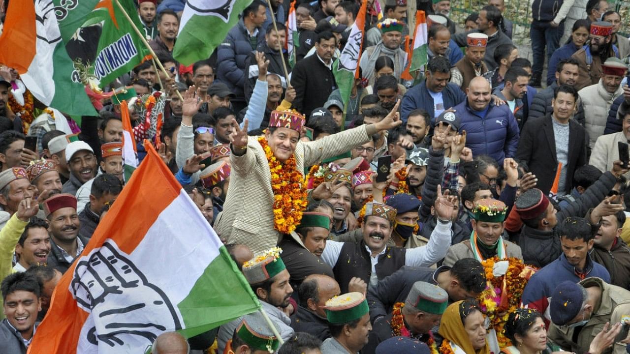 Congress candidate Sunder Singh Thakur celebrates his win with supporters on the counting day of the Himachal Pradesh Assembly elections, in Kullu. Credit: PTI Photo