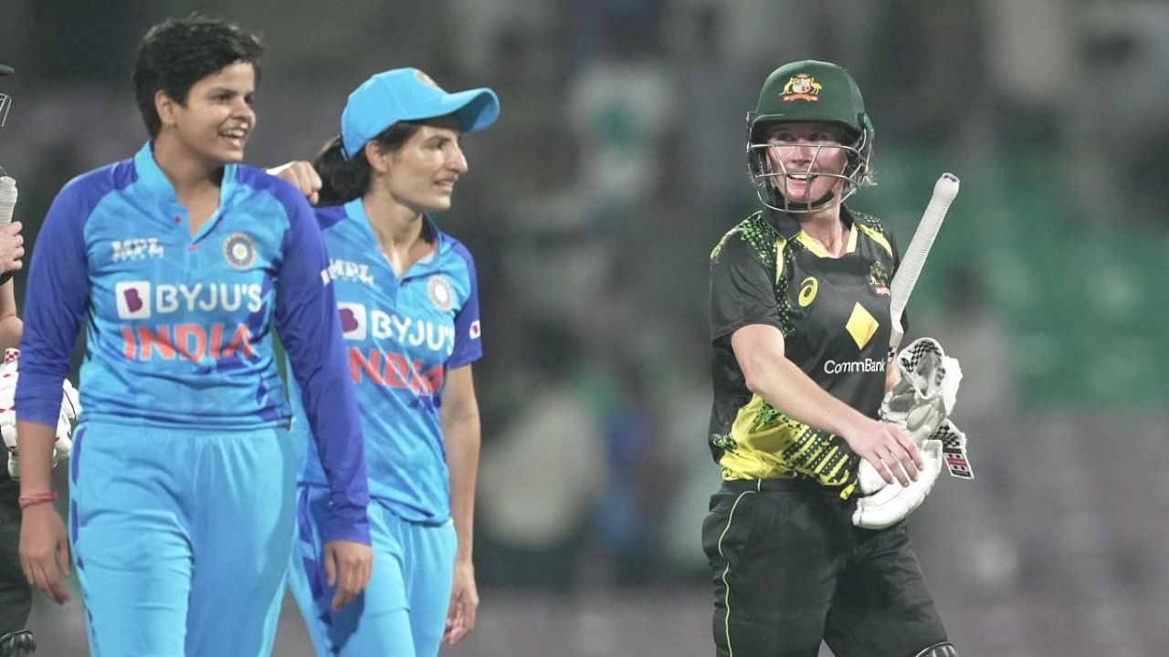 Australian player Beth Mooney and Tahlia McGrath walk back after winning the match during the T20 International series between India and Australia at Dr DY Patil Cricket Stadium, in Navi Mumbai, Friday, Dec. 9, 2022. Credit: PTI Photo