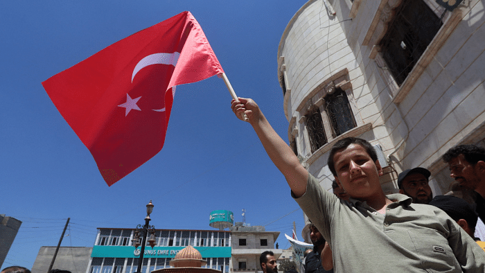 Man holding flag of Turkey. Credit: AFP Photo