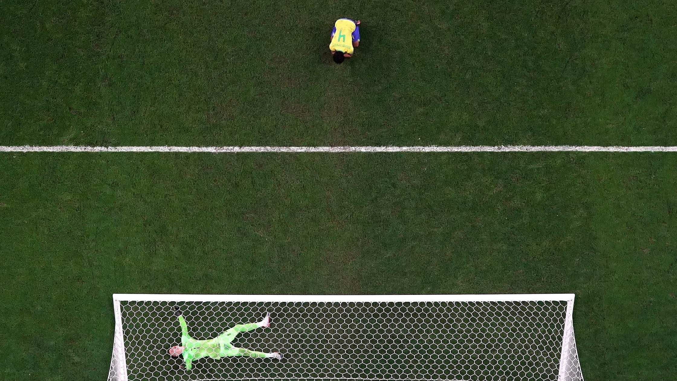Croatia's Dominik Livakovic celebrates qualifying for the semi finals after saving a penalty missed by Brazil's Marquinhos. Credit: Reuters Photo