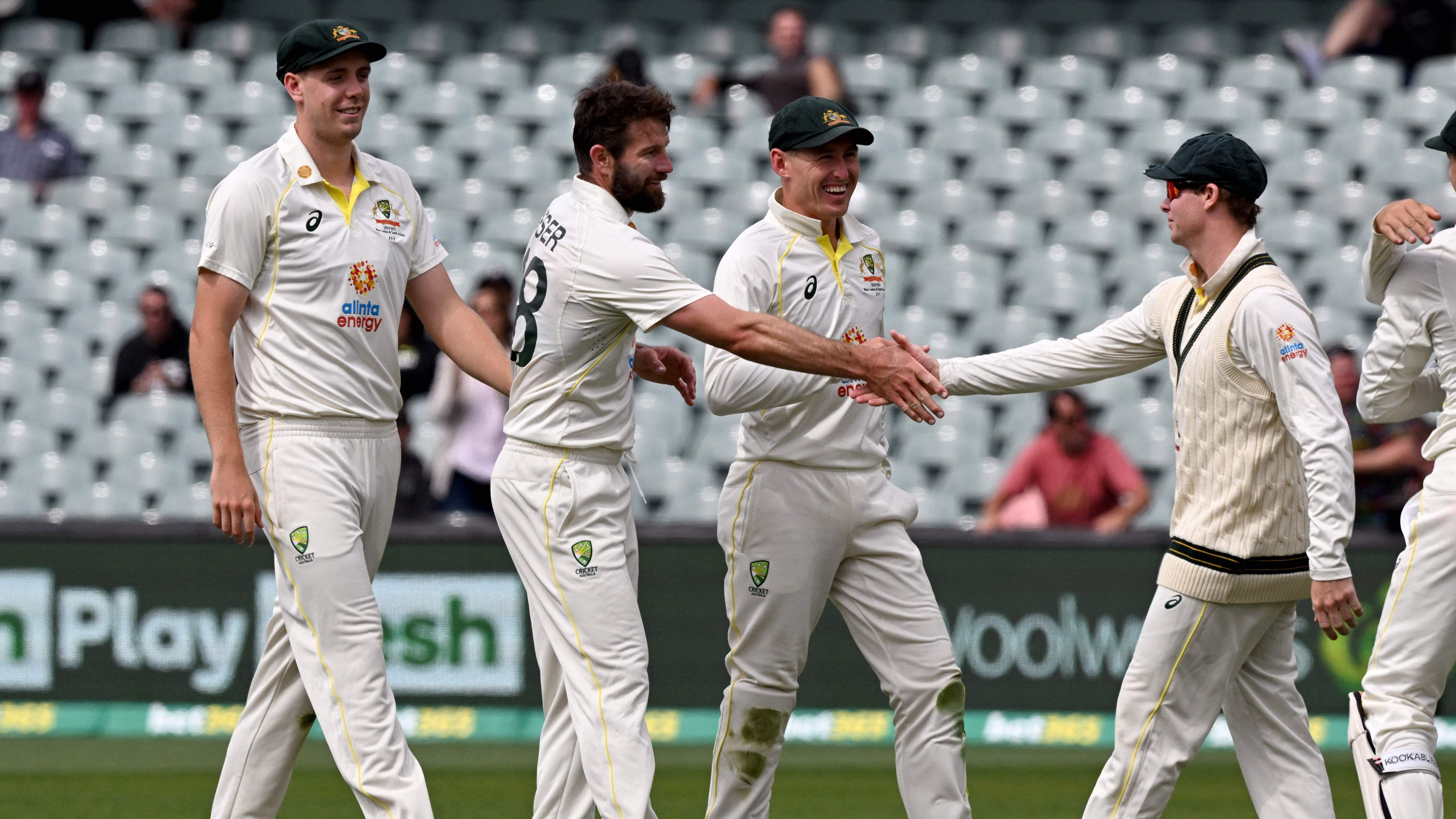 Australia's Michael Neser (2nd L) is congratulated by captain Steve Smith (R) after their victory during the fourth day of the second cricket Test match between Australia and the West Indies at the Adelaide Oval. Credit: AFP Photo 