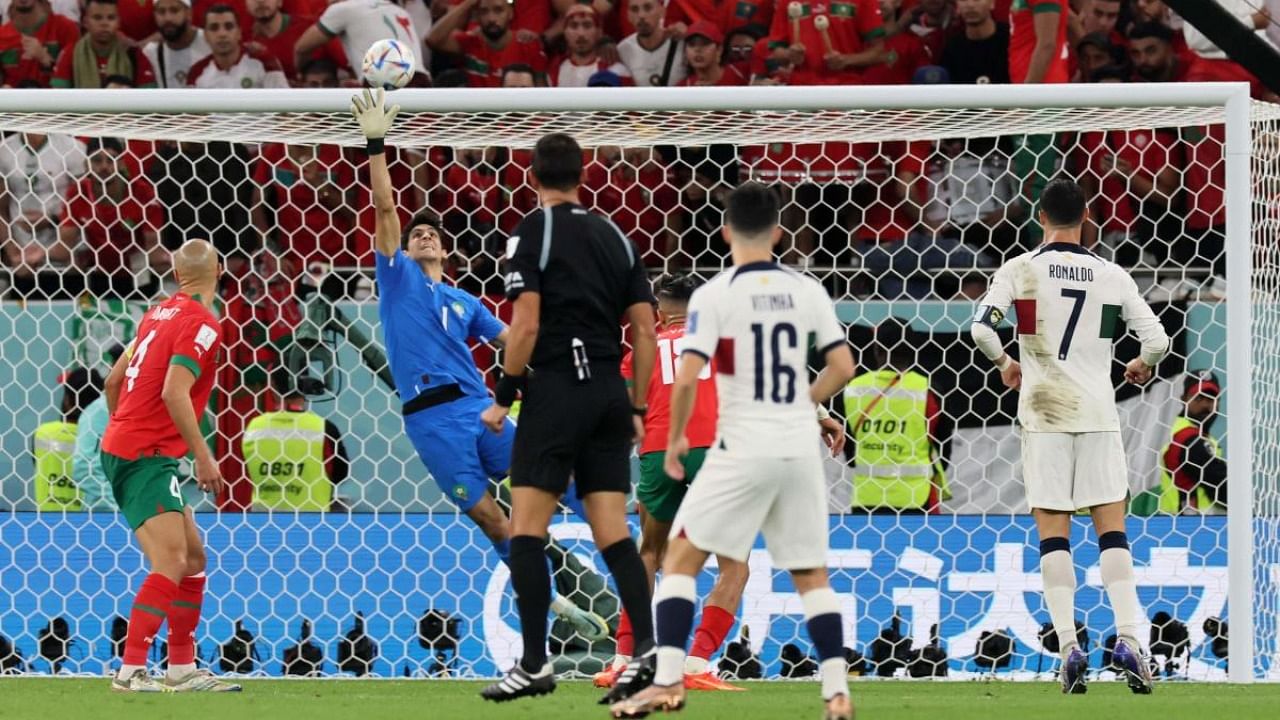 Morocco's goalkeeper #01 Yassine Bounou deflects a shot during the Qatar 2022 World Cup quarter-final football match between Morocco and Portugal at the Al-Thumama Stadium in Doha. Credit: AFP Photo