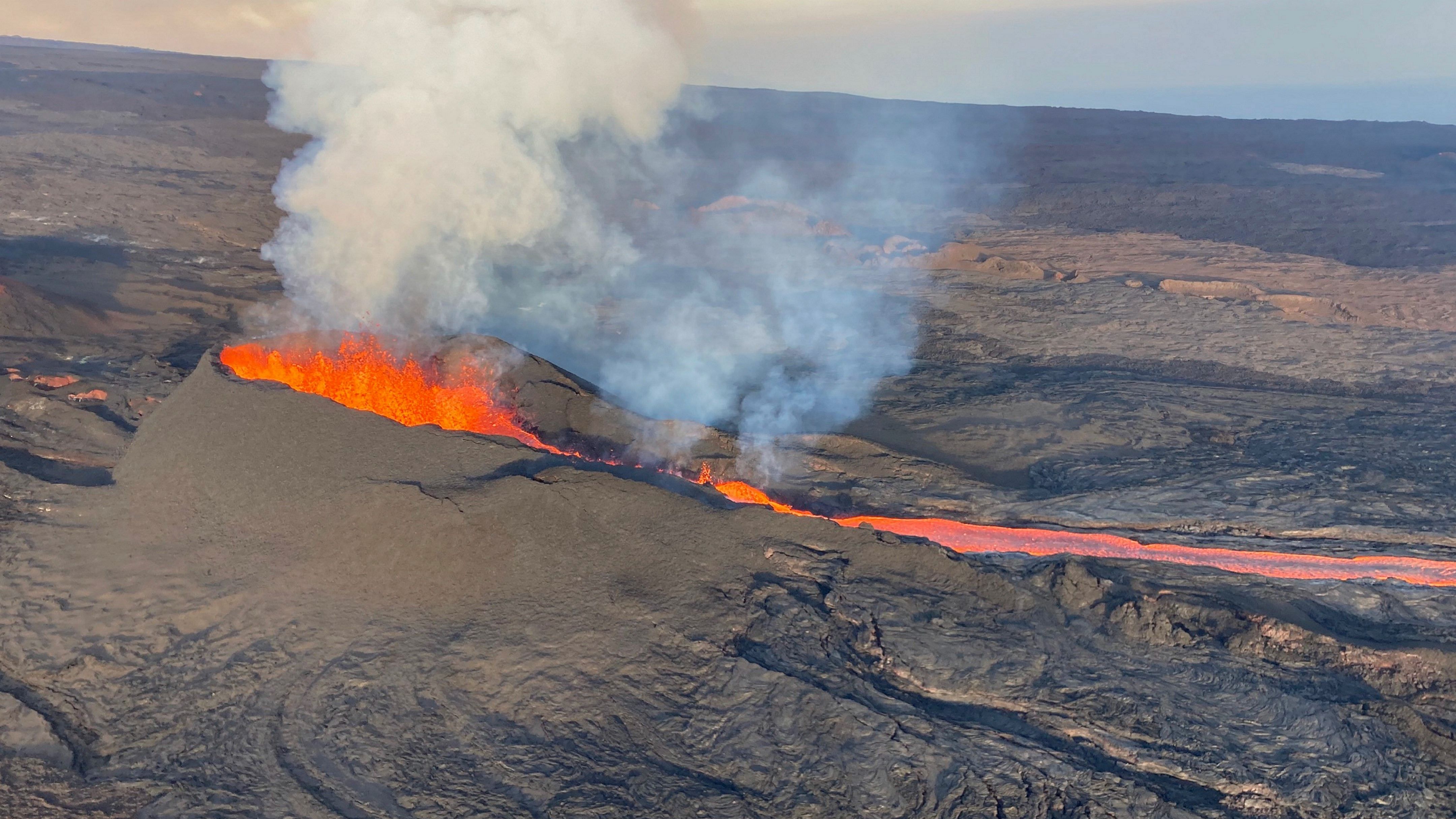 In this aerial image provided by the U.S. Geological Survey, fissure 3 is seen erupting on the Northeast Rift Zone of Mauna Loa on the Big Island of Hawaii, Wednesday, Dec. 7, 2022. Credit: AP/PTI