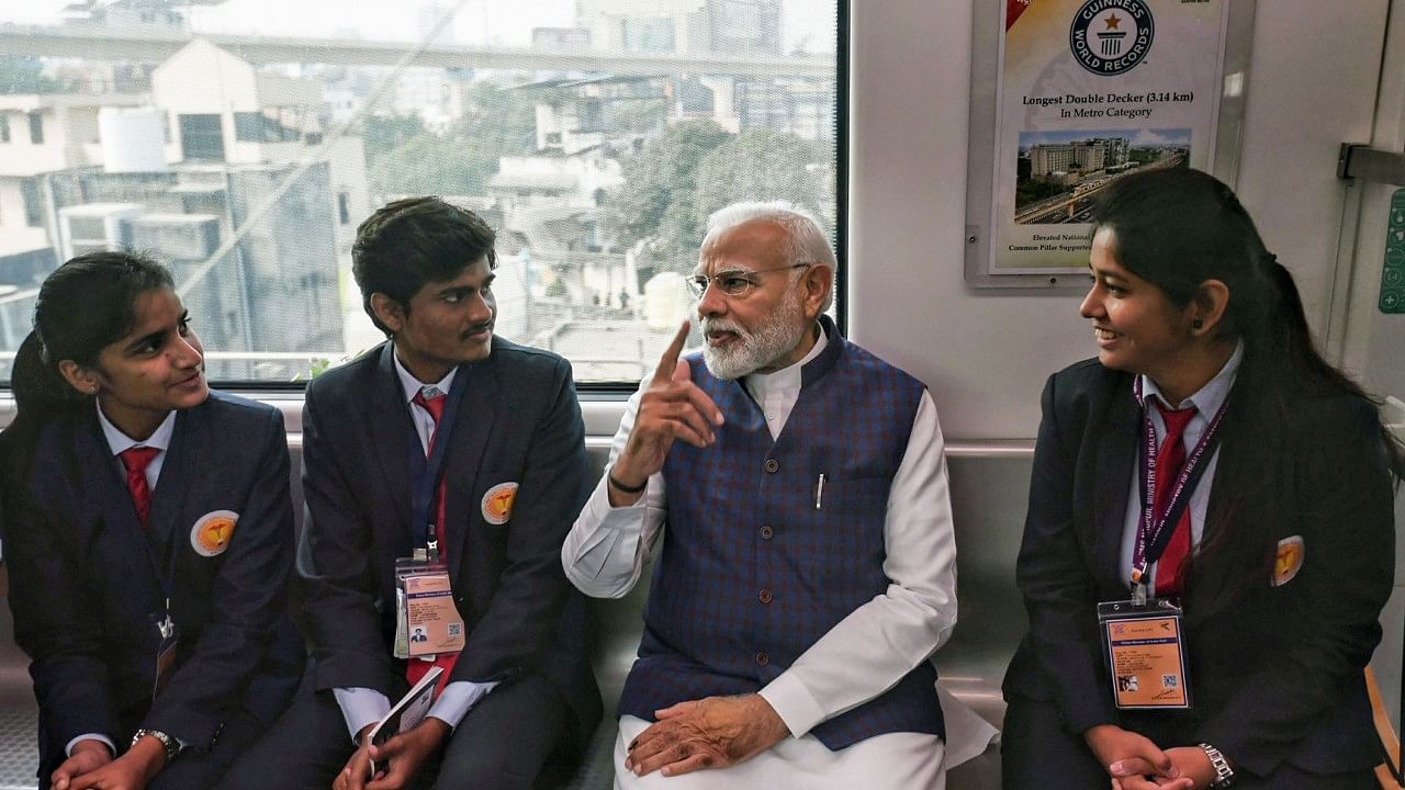 Prime Minister Narendra Modi interacts with students as he takes Metro ride from Freedom Park Metro station to Khapri Metro Station, in Nagpur, Sunday, Dec. 11, 2022. Credit: PTI Photo