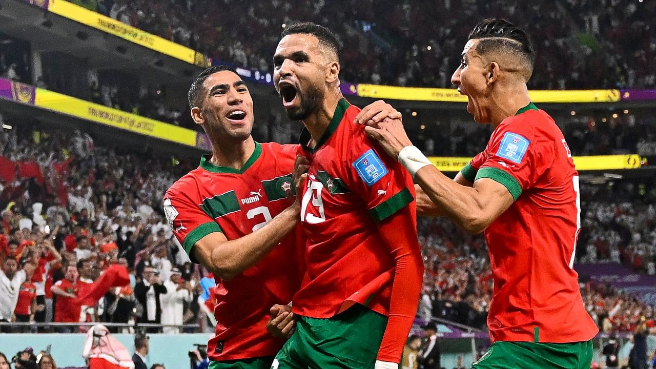 Youssef En-Nesyri (C) celebrates with teammates after scoring the opening goal against Portugal, December 10, 2022. Credit: AFP Photo