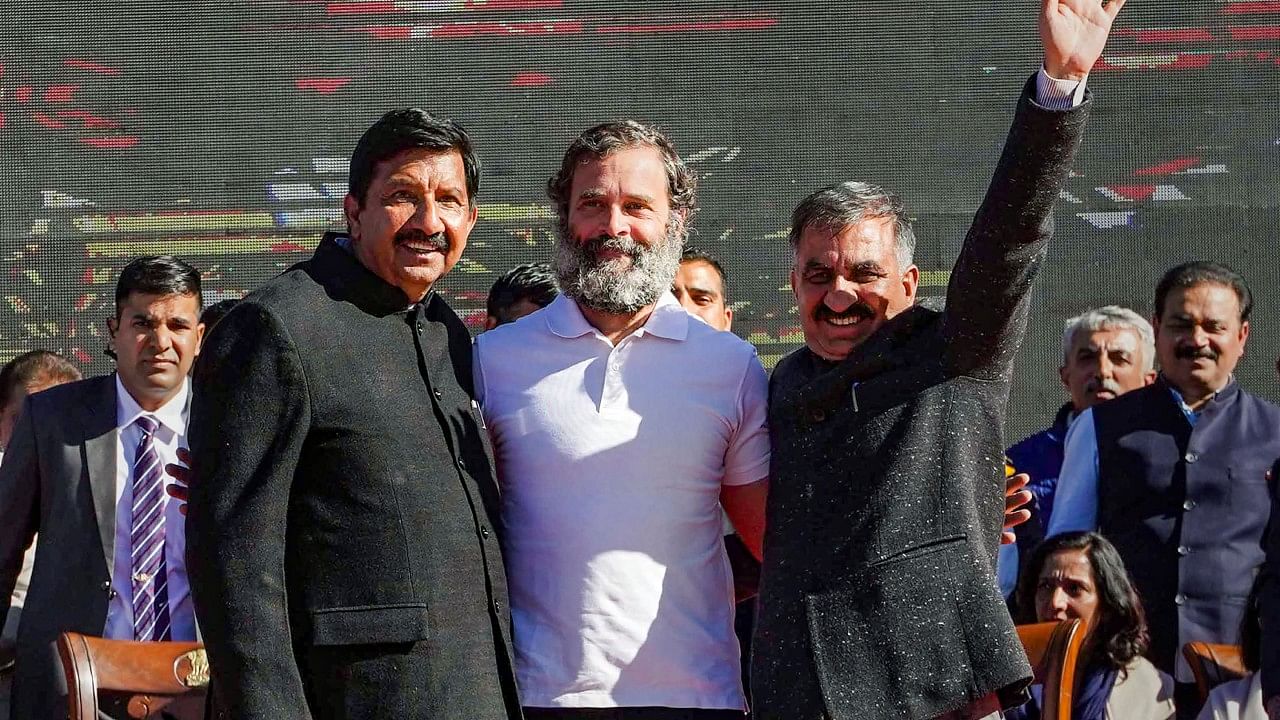 Himachal Pradesh Chief Minister Sukhvinder Singh Sukhu (R) and his deputy Mukesh Agnihotri (L) with Congress leader Rahul Gandhi after the swearing-in ceremony, in Shimla, Sunday, Dec. 11, 2022. Credit: PTI Photo