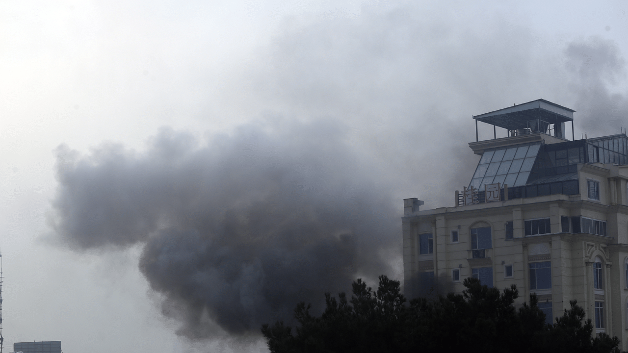 Smoke rises from a hotel building after an explosions and gunfire in the city of Kabul. Credit: AP/PTI Photo 