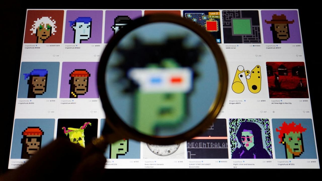 A non-fungible token (NFT) displayed on the website of NFT marketplace OpenSea is seen through a magnifying glass, in this illustration picture taken February 28, 2022. Credit: Reuters Photo