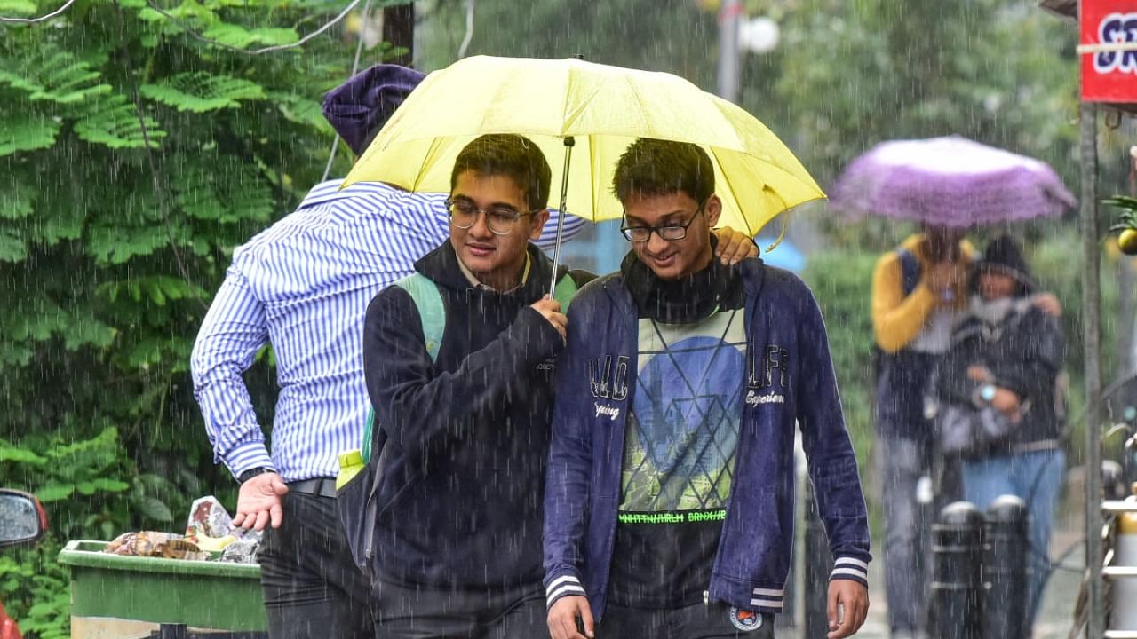 Boys enjoy the rain on Monday evening at Church Street. Credit: DH Photo