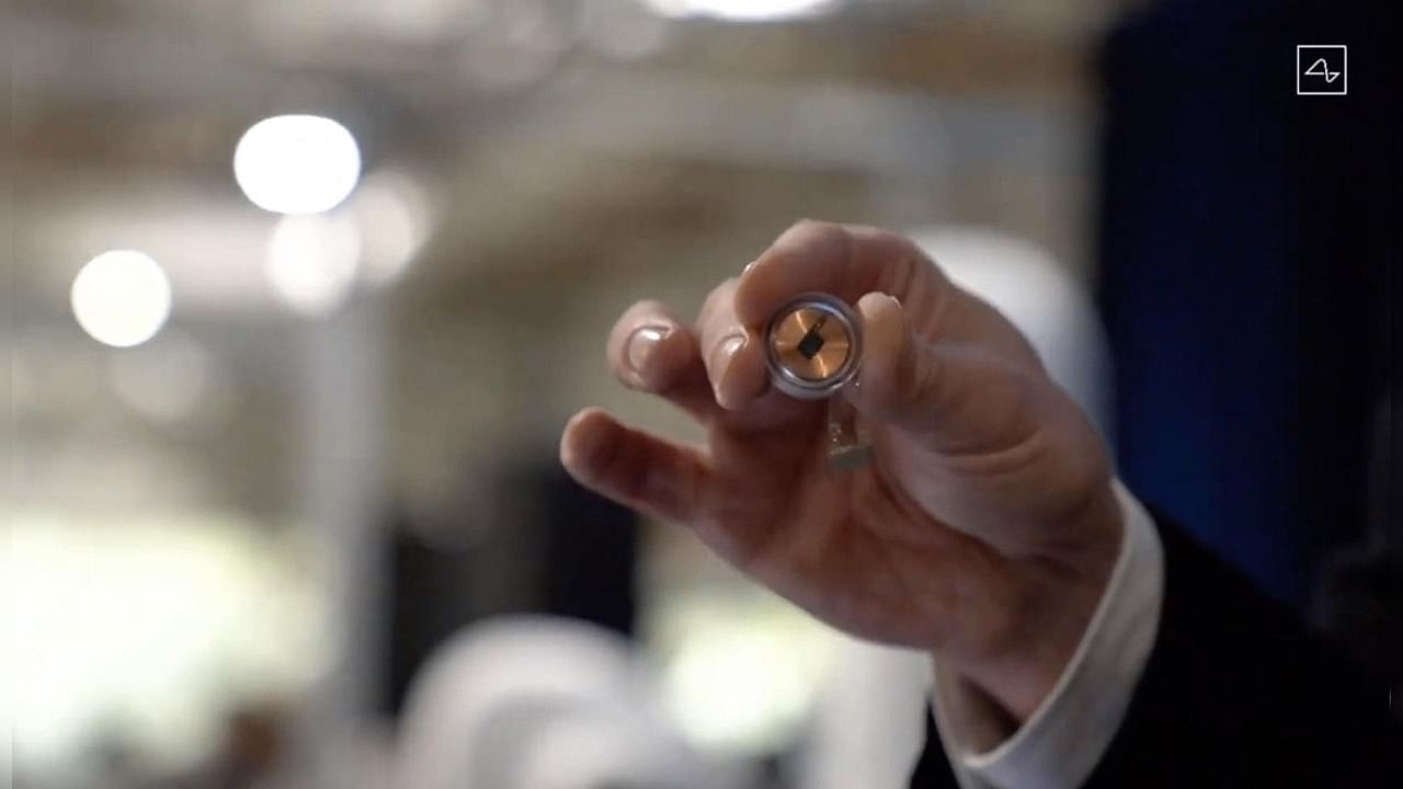 This video grab made from the online Neuralink livestream shows the Neuralink disk implant held by Elon Musk during the presentation on August 28, 2020. Credit: AFP Photo/Neuralink