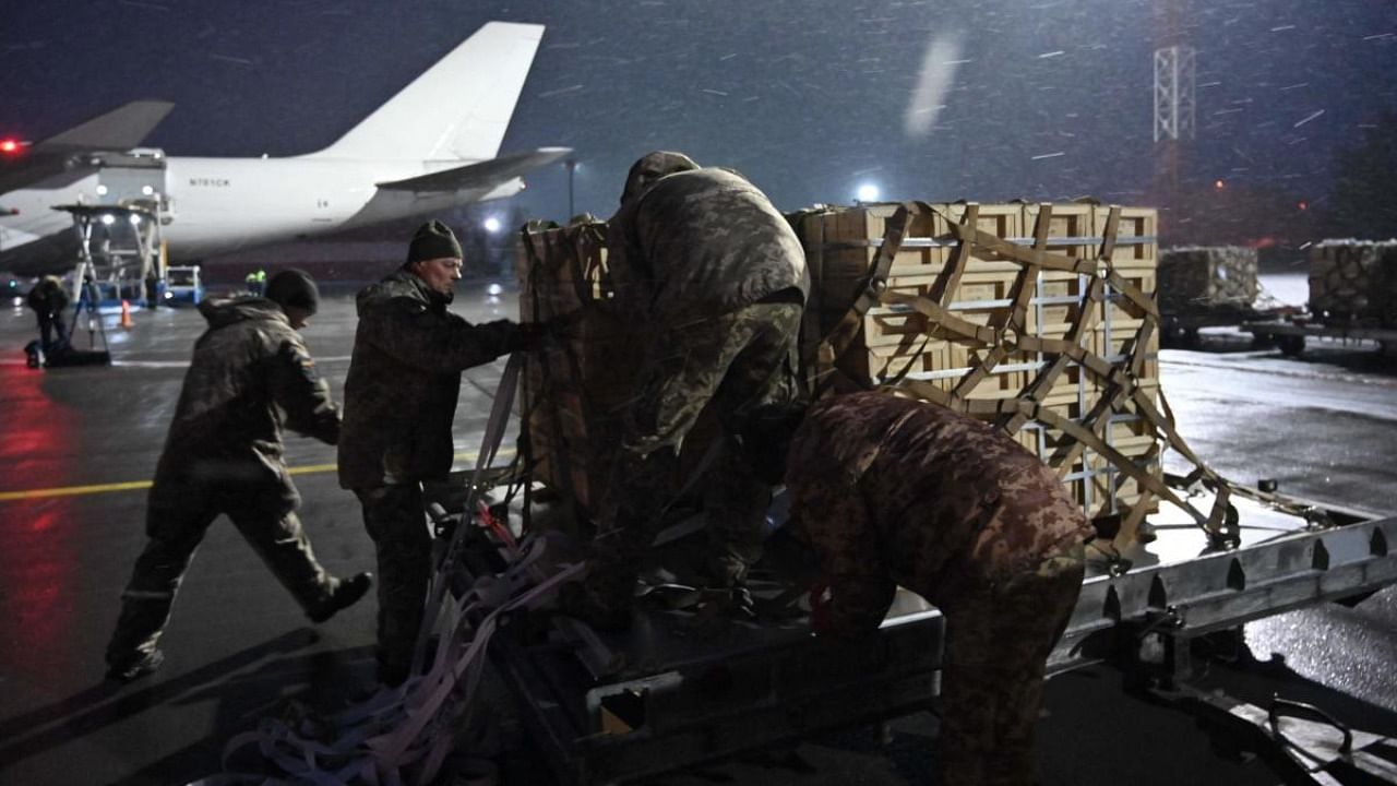 In this file photo taken on February 05, 2022 Ukrainian Military Forces servicemen unload a plane carrying US military aid at Kyiv's Boryspil airport on February 5, 2022. Credit: AFP Photo