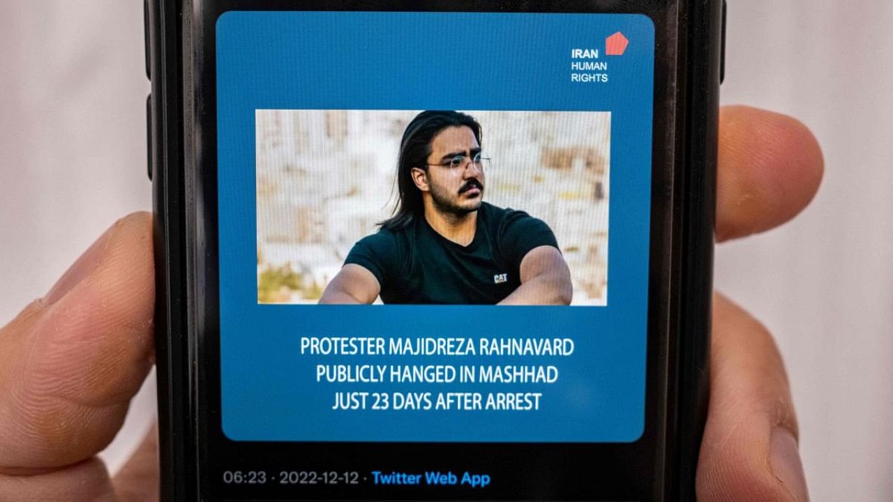 A person in the Cypriot capital Nicosia checks a mobile phone displaying a Tweet about the execution announced by Iranian authorities of Majidreza Rahnavard, the second capital punishment linked to nearly three months of protests. Credit: AFP Photo