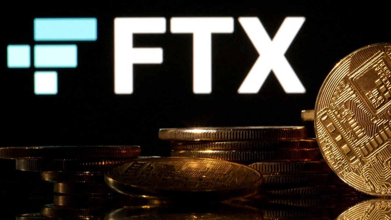 Representations of cryptocurrencies are seen in front of displayed FTX logo in this illustration taken November 10, 2022. Credit: Reuters Photo