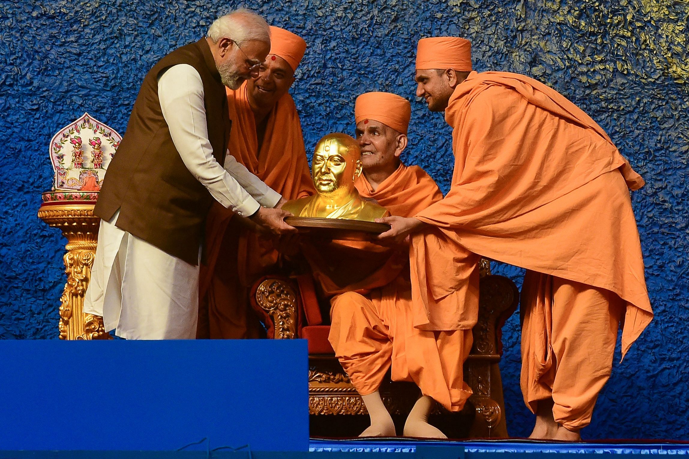 Prime Minister Narendra Modi (L) receives a bust of Pramukh Swami from BAPS Chief Mahant Swami during inauguration of the Pramukh Swami centenary celebrations. Credit: AFP Photo