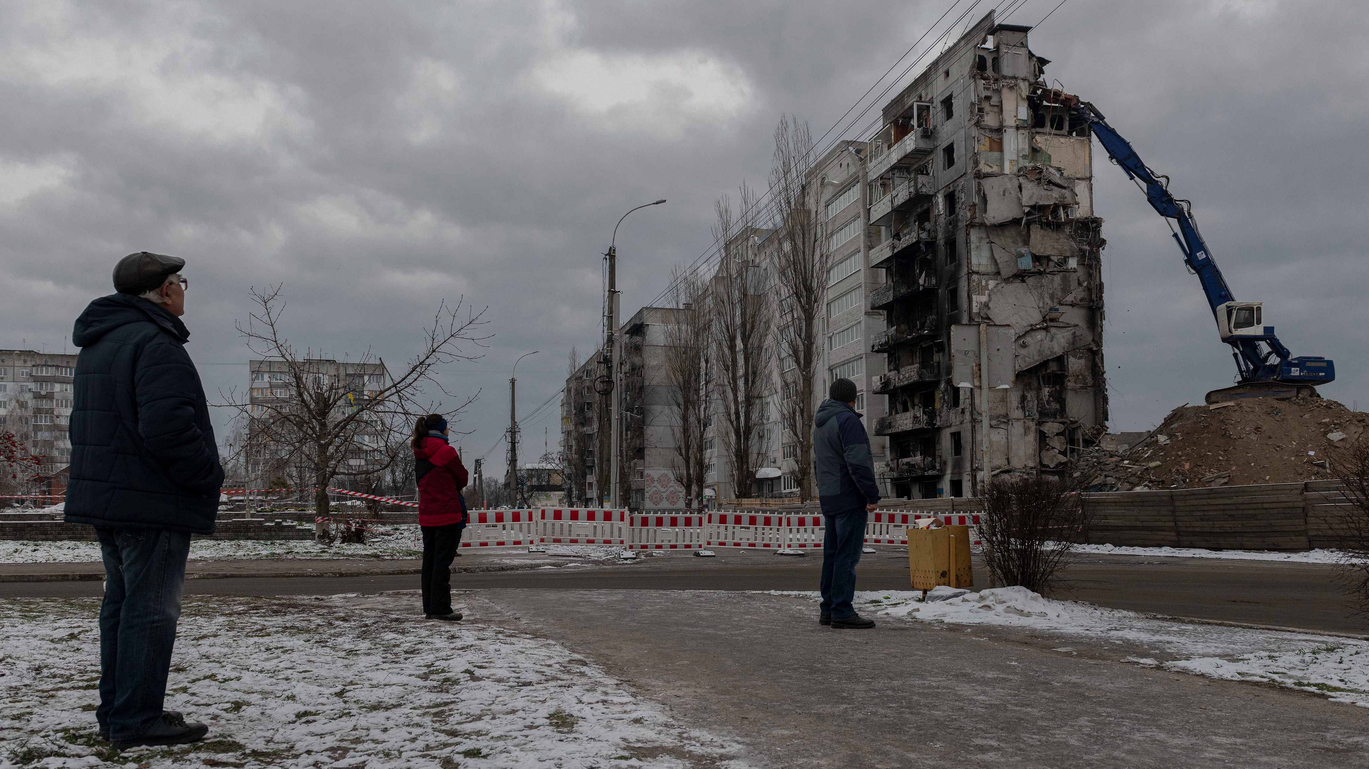 Local residents watch as a bombed building is dismantled in Borodyanka, Kyiv region, Ukraine. Credit: AP/PTI Photos