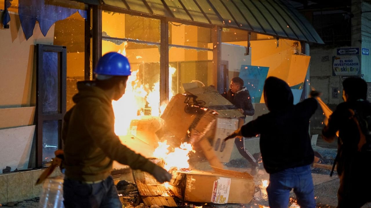 Protesters vandalize the entrance of CTC TV Channel of Cuzco during a protest demanding the dissolution of the Congress and to hold democratic elections rather than recognising Dina Boluarte as Peru's President, after the ouster of Peruvian leader Pedro Castillo, in Cuzco, Peru. Credit: Reuters Photo