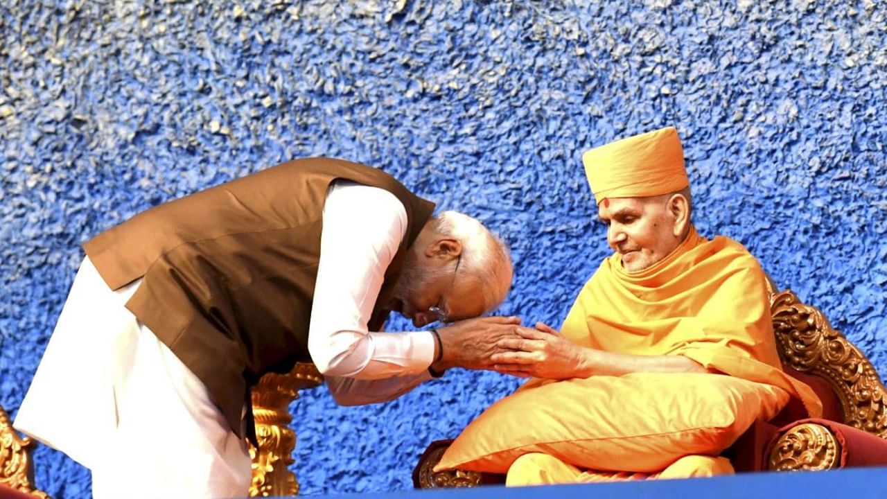 Prime Minister Narendra Modi gets blessings from Mahant Swami Chief of BAPS during the inaugural ceremony of month-long Pramukh Swami Maharaj centenary celebrations. Credit: PTI Photo