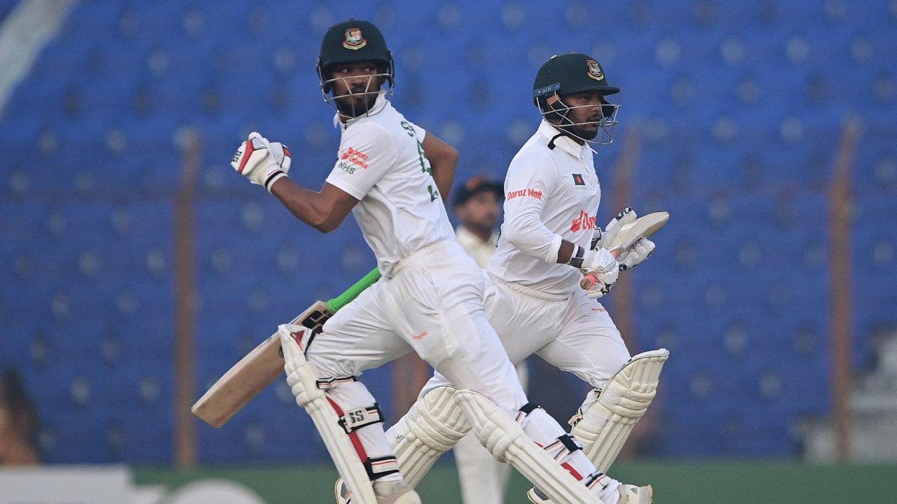 Bangladesh's Najmul Hossain Shanto (L) and Zakir Hasan run between the wickets during the third day of the first cricket Test match between Bangladesh and India. Credit: AFP Photo 