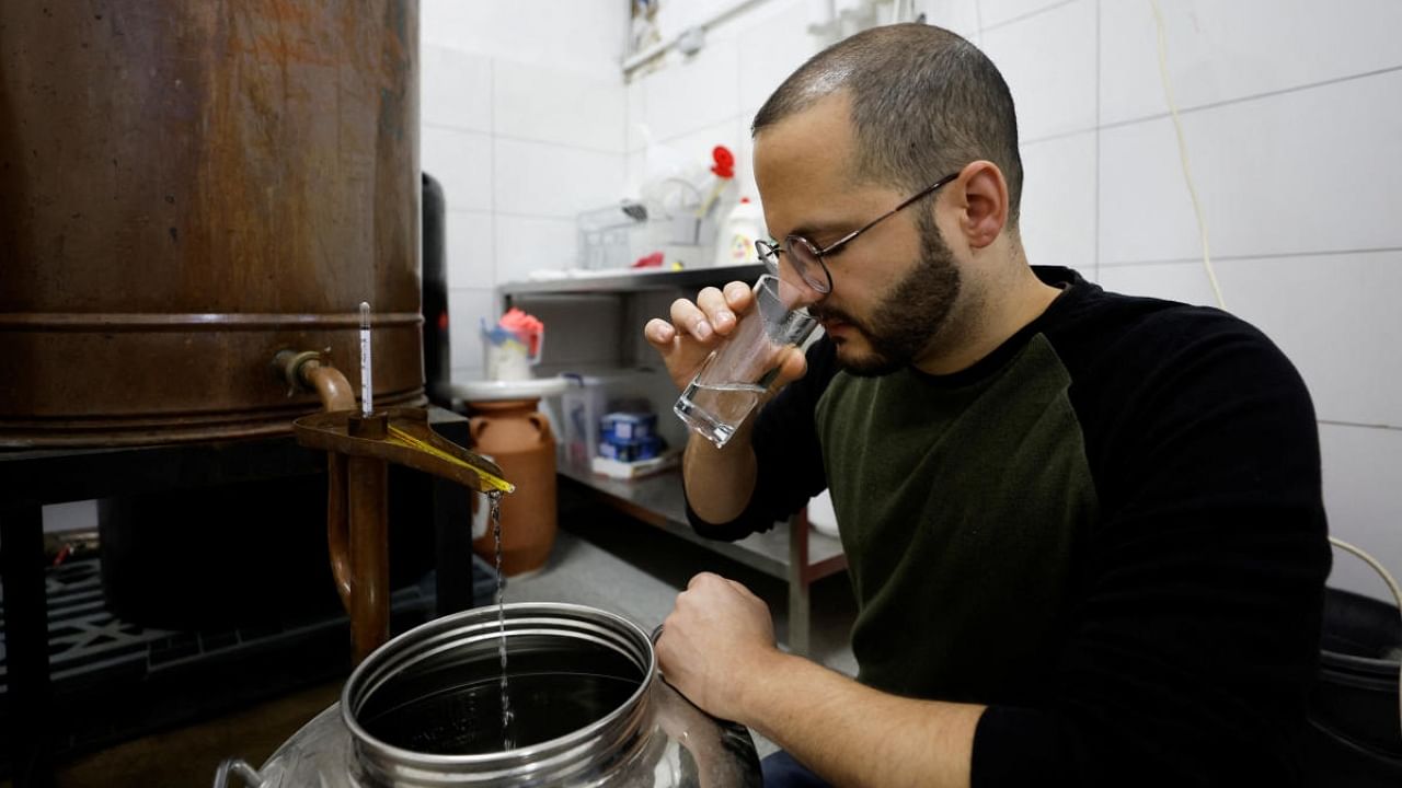 Palestinian Nader Muaddi smells alcohol at his family distillery in Bethlehem, in the Israeli-occupied West Bank. Credit: Reuters Photo