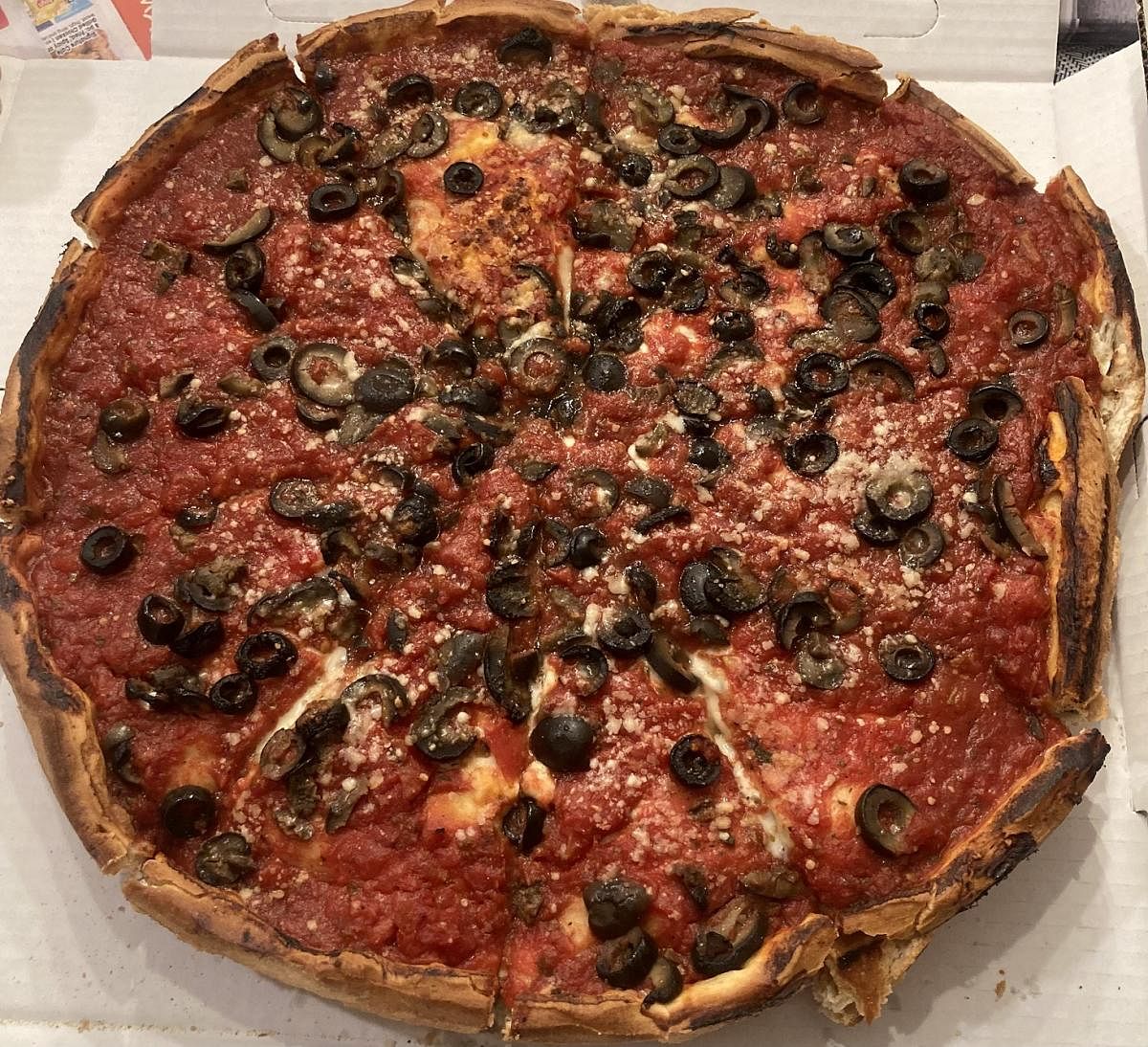 Deep-dish pizza topped with olives. PHOTOS BY AUTHOR