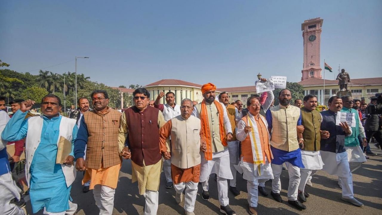 LoP in the Bihar Assembly and BJP leader Vijay Kumar Sinha with legislators shouts slogans at a protest against Bihar government over the Chhapra Hooch tragedy. Credit: PTI Photo