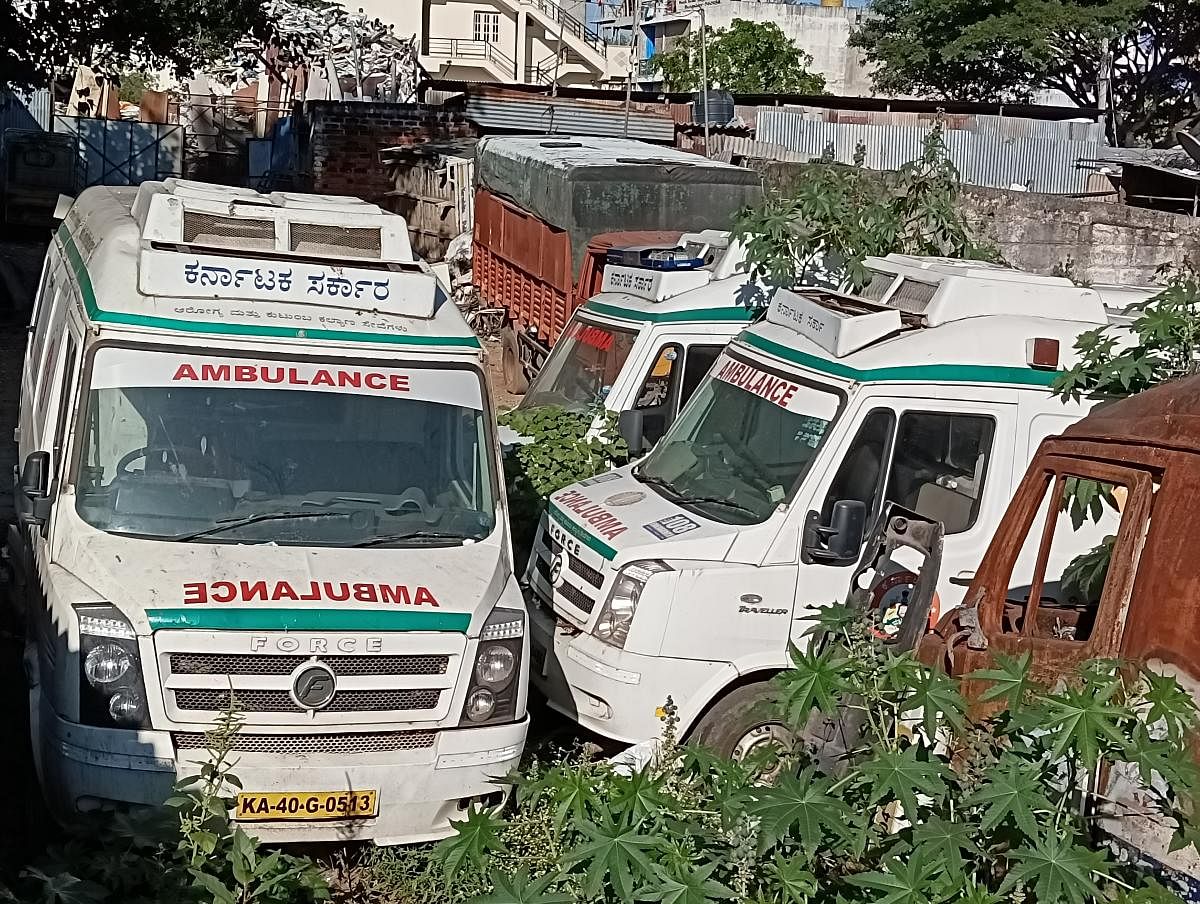 Ambulances parked unattended in a garage parking. There were ten ambulances which were not serviced for six months as the garage owner says he owes Rs 12 lakh from the company. DH Photo/ Shree D N