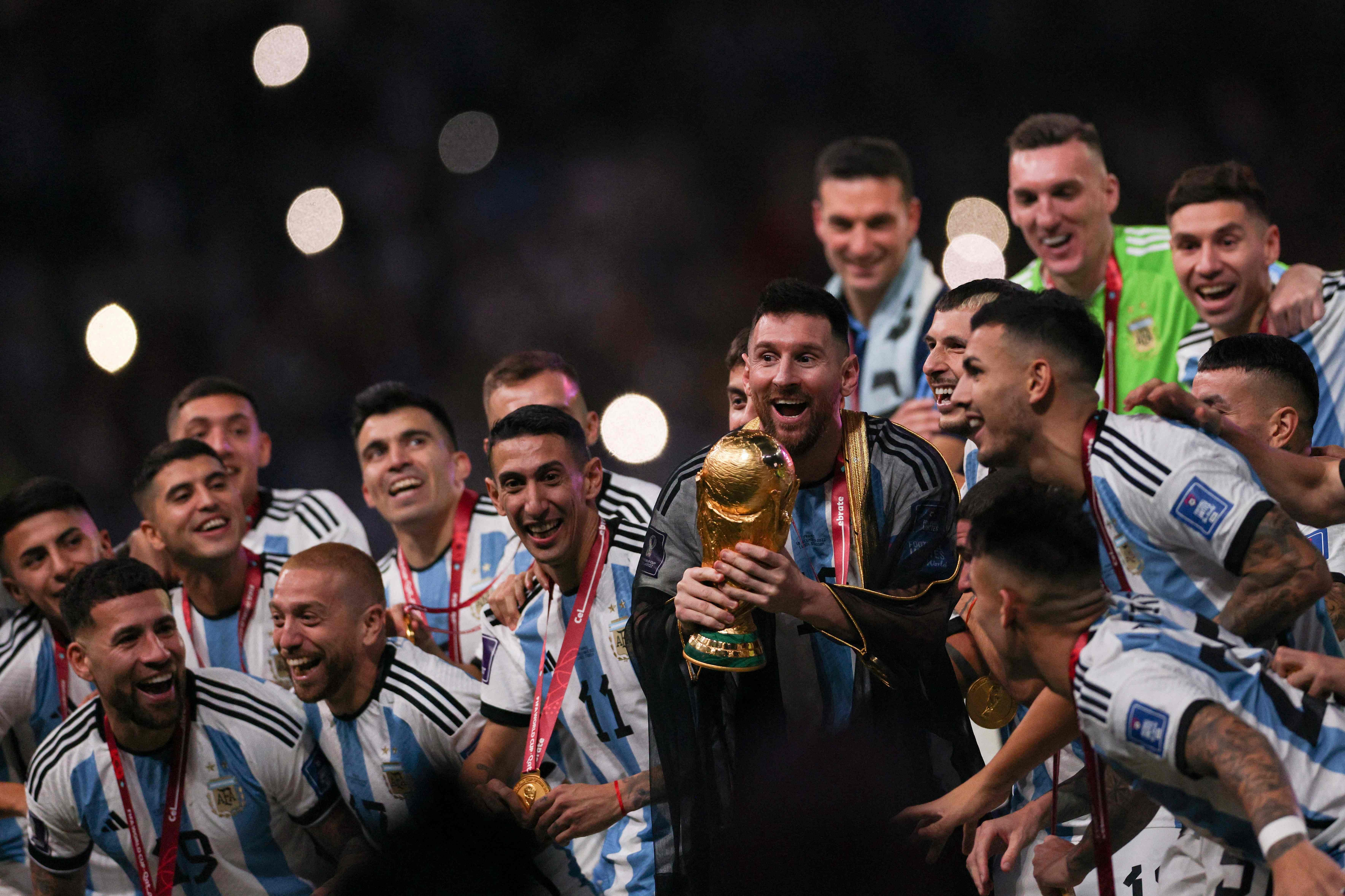 Argentina's captain and forward Lionel Messi lifts the FIFA World Cup Trophy. Credit: AFP Photo