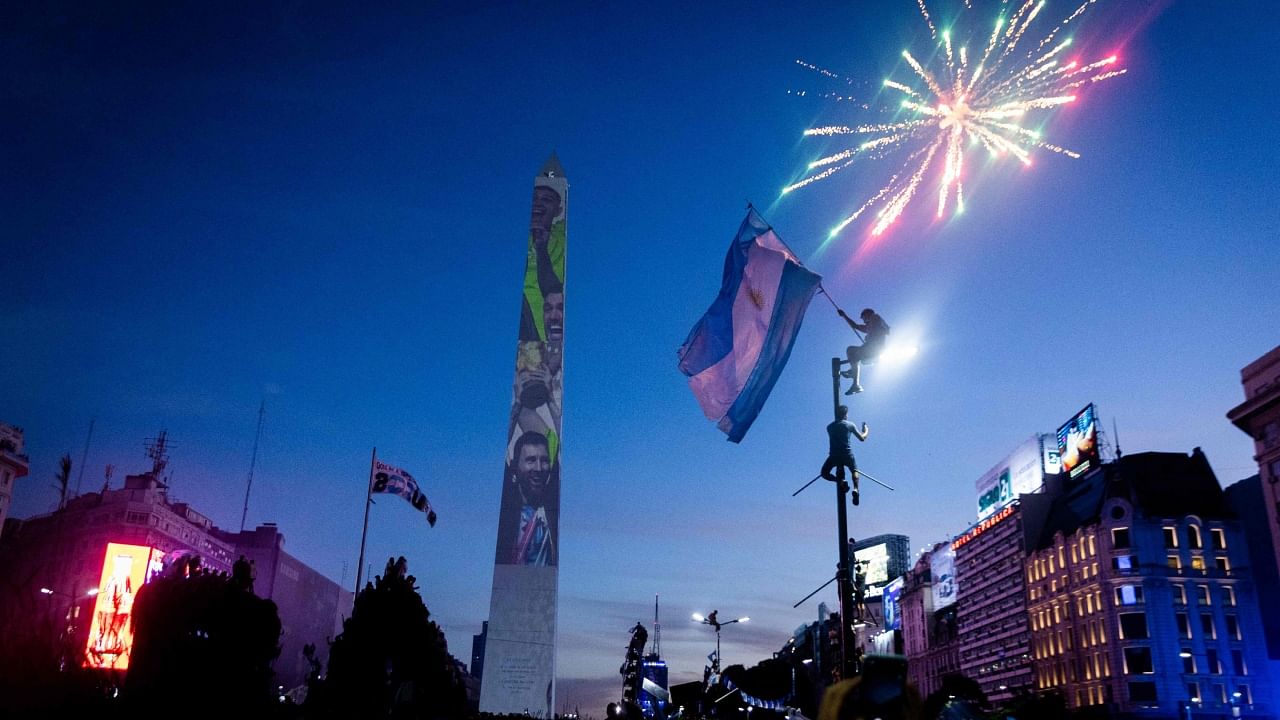 Fans of Argentina celebrate winning the Qatar 2022 World Cup against France at the Obelisk in Buenos Aires, on December 18, 2022. Credit: AFP Photo