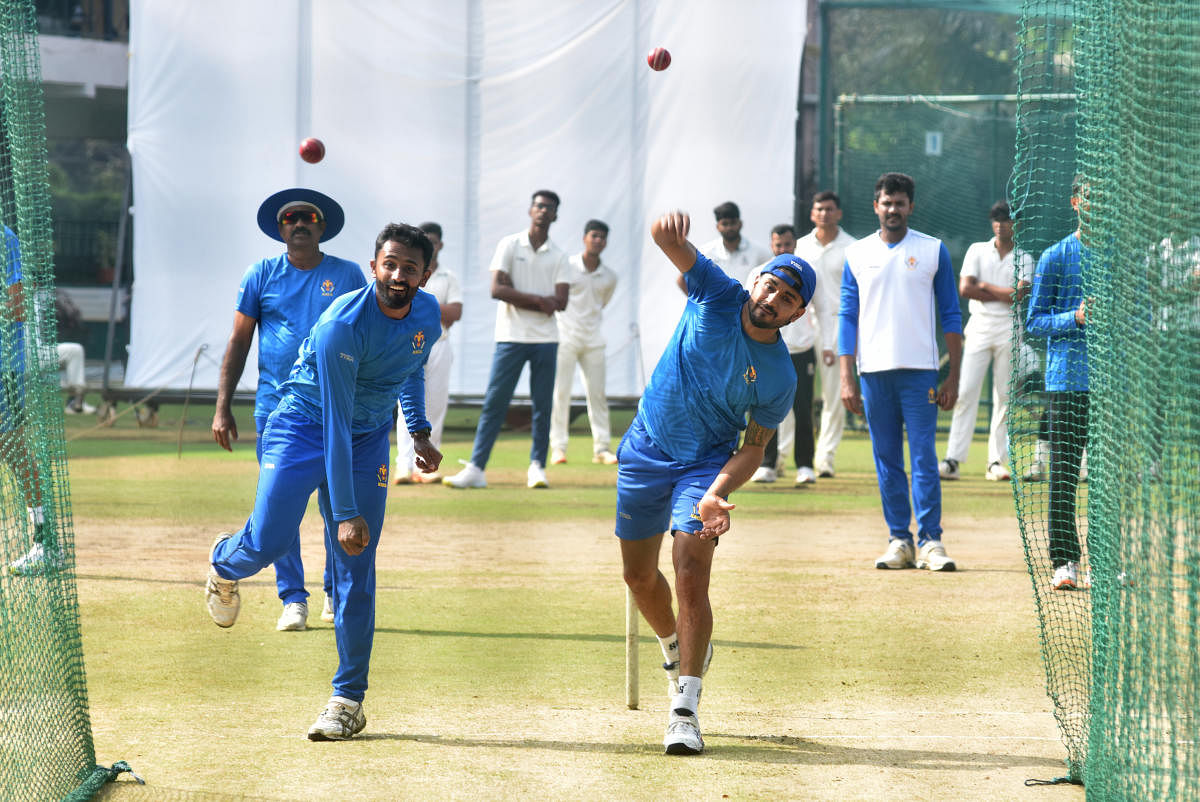 Karnataka batter Manish Pandey (right) appears to impersonate leg-spinner Shreyas Gopal during a training session on Monday. Credit: DH Photo/ B K Janardhan