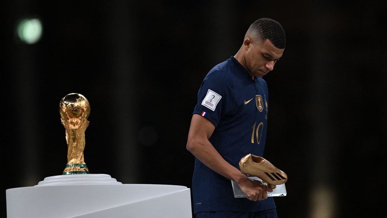 Kylian Mbappe walks past the FIFA World Cup trophy after collecting his Golden Boot award. Credit: AFP Photo