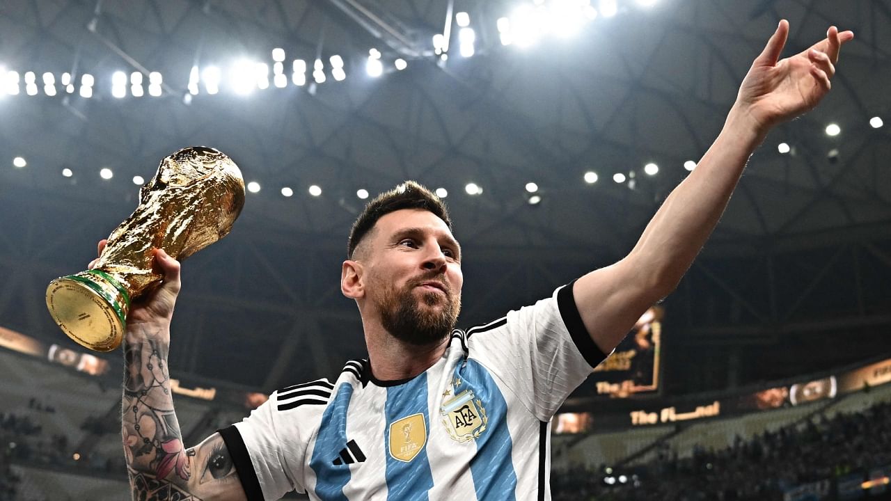 Lionel Messi poses with the FIFA World Cup trophy after Argentina's win over France on penalties in the final. Credit: AFP Photo