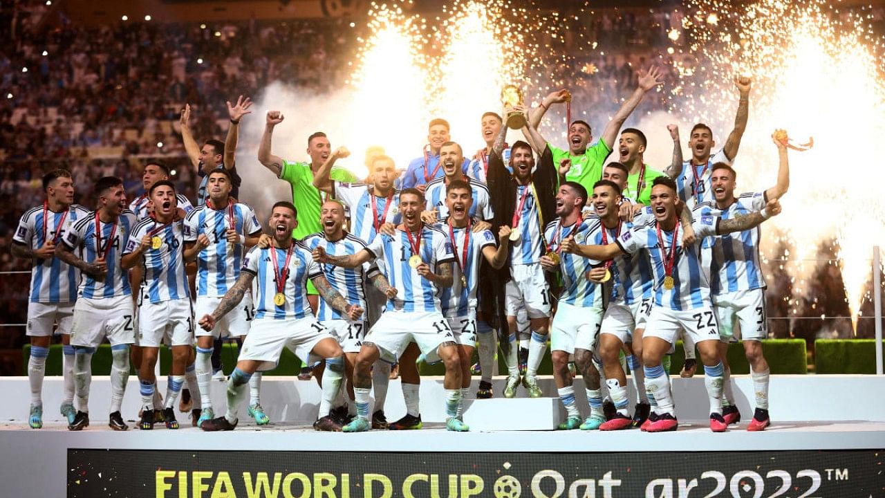 Argentina's Lionel Messi celebrates with the trophy and teammates after winning the World Cup. Credit: Reuters Photo