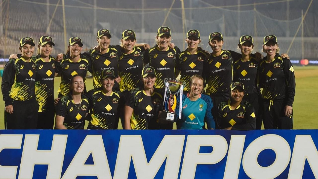 Australia's women’s cricket team pose with the trophy after winning the fifth women’s T20 cricket match between India and Australia. Credit: AFP