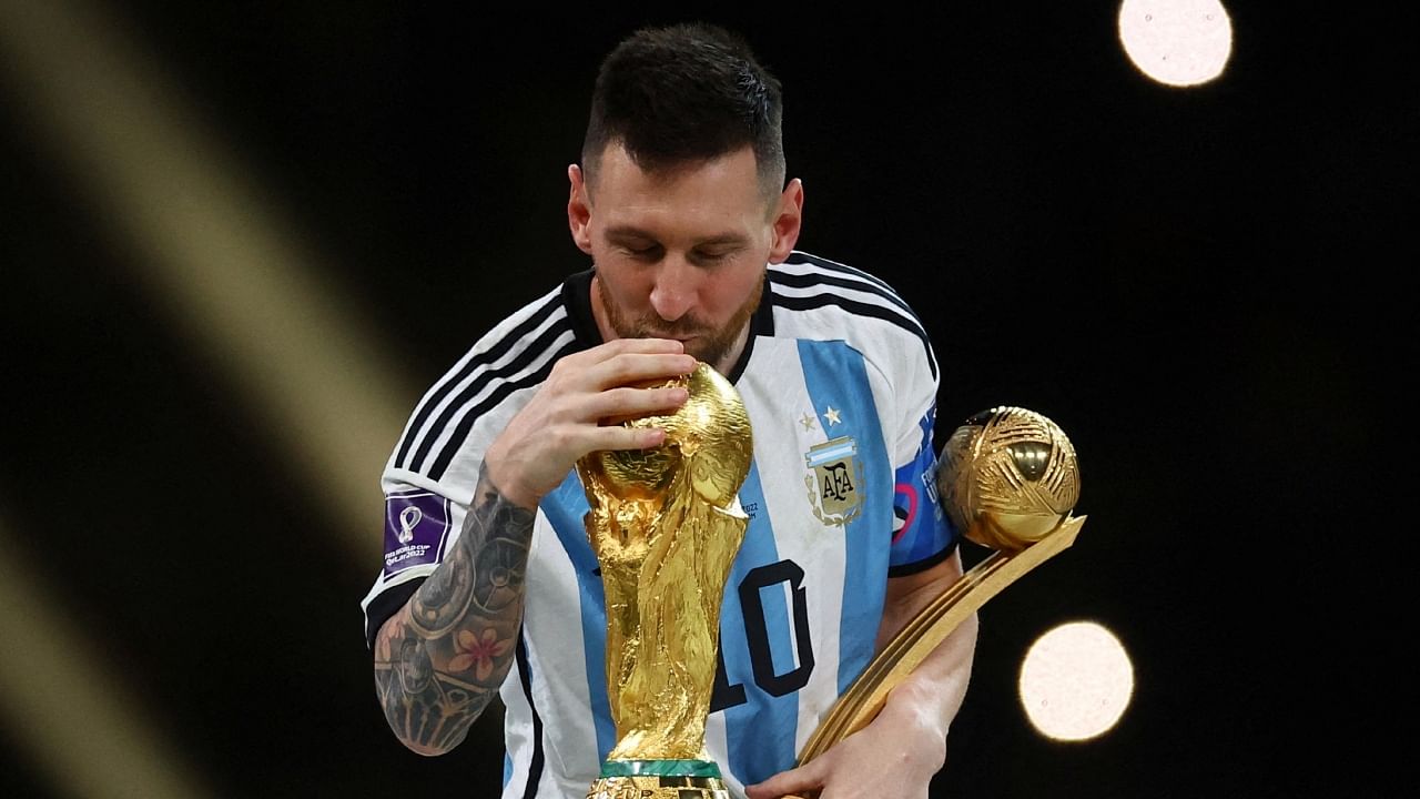 Lionel Messi kisses the World Cup trophy after receiving the Golden Ball award. Credit: Reuters Photo