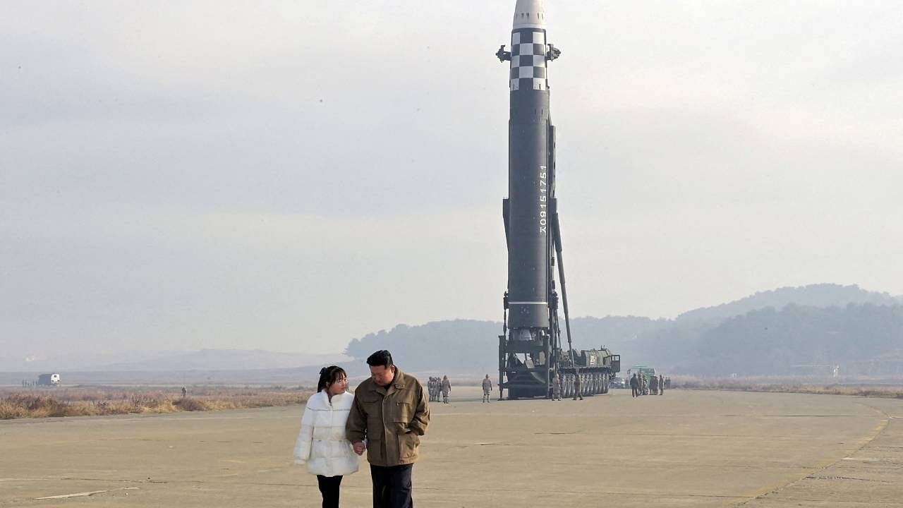 North Korean leader Kim Jong Un, along with his daughter, walks away from an ICBM in this undated photo. Credit: Reuters Photo