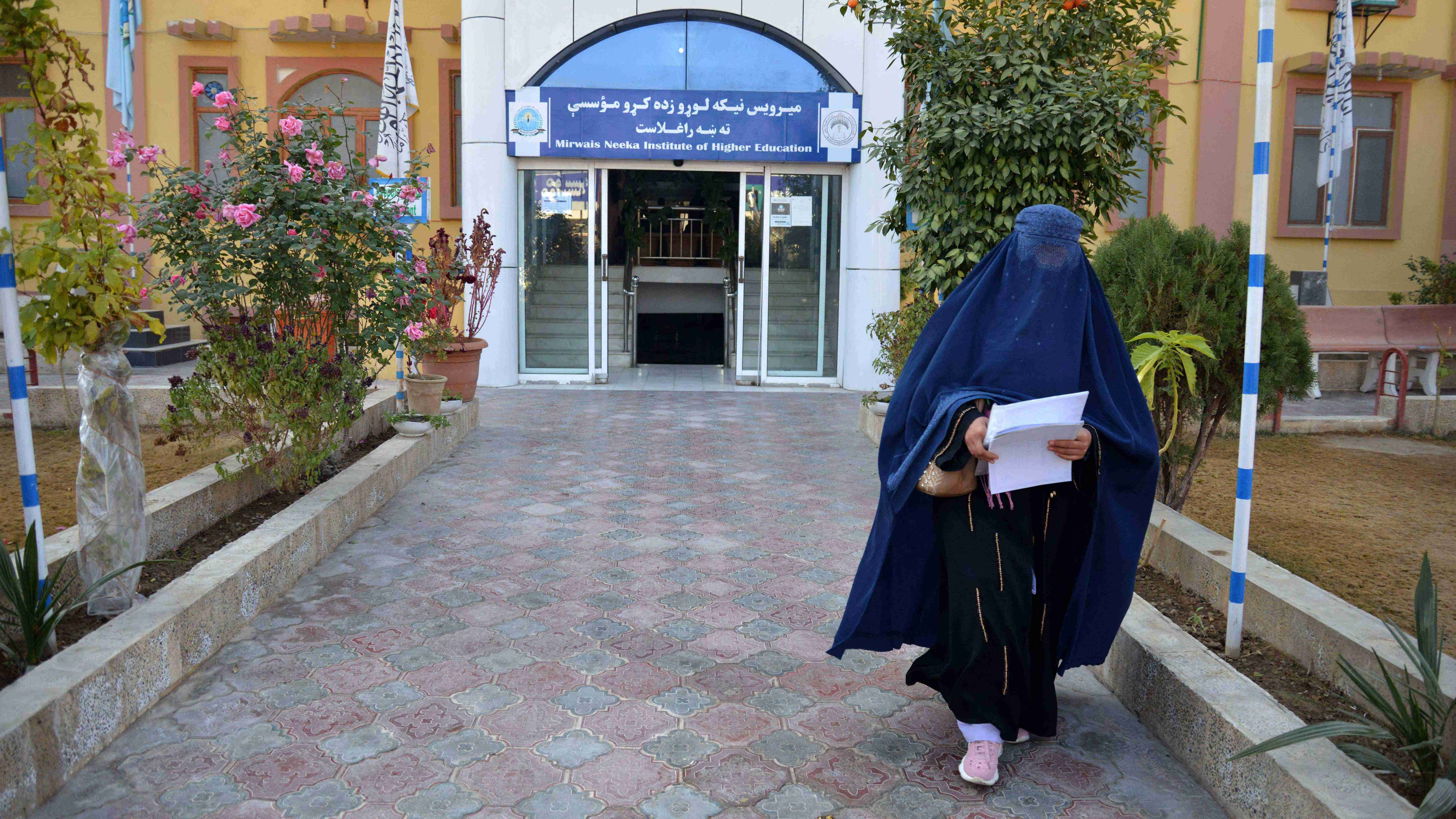 A female university Student walks in front of a university in Kandahar Province on December 21, 2022. Credit: AFP Photo