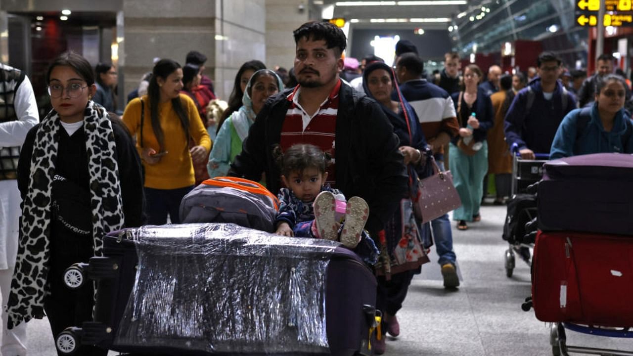 Travellers push trolleys with their luggage at the departure area of Indira Gandhi International Airport in New Delhi. Credit: Reuters Photo